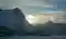 Mountain with the sun shining behind it
